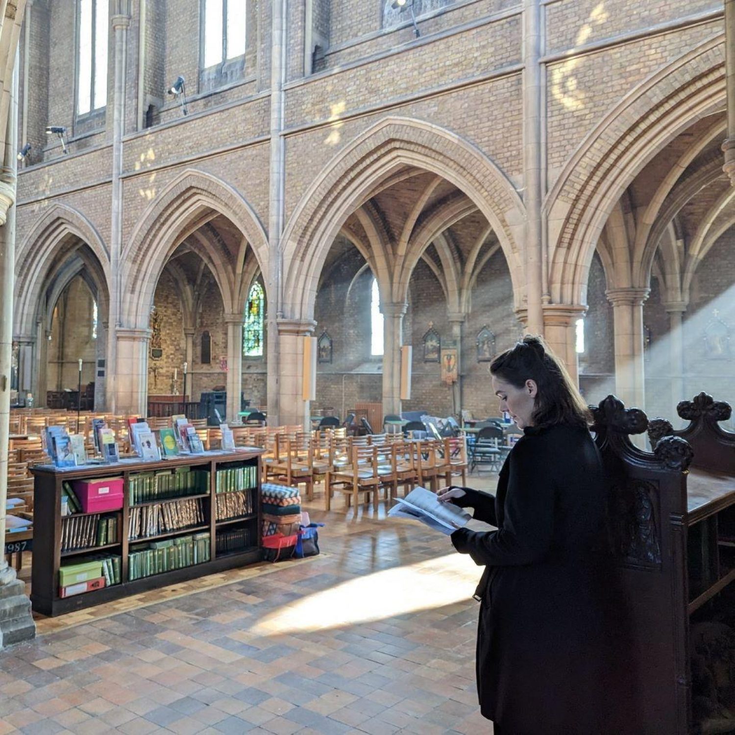 Chloe Miller Smith, funeral director on the day for Poppy's in church with light streaming in