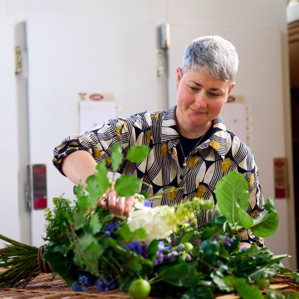 Amy adjusting flowers on coffin