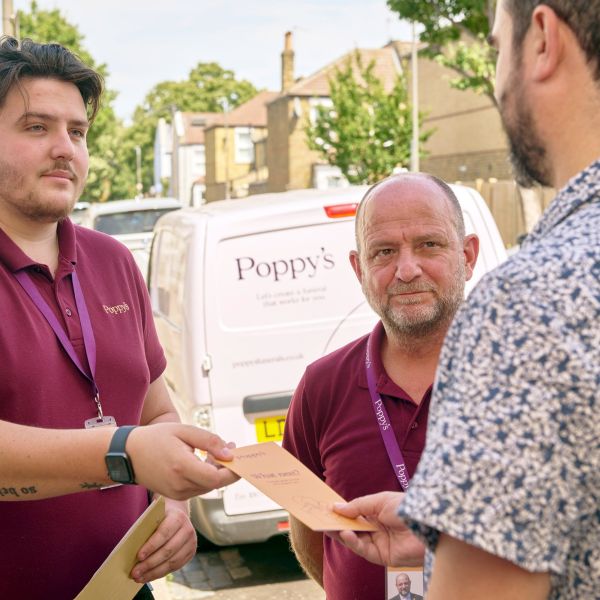 Handing client leaflet at the door of a home collection
