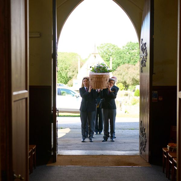 Bearers practical leads bringing coffin in