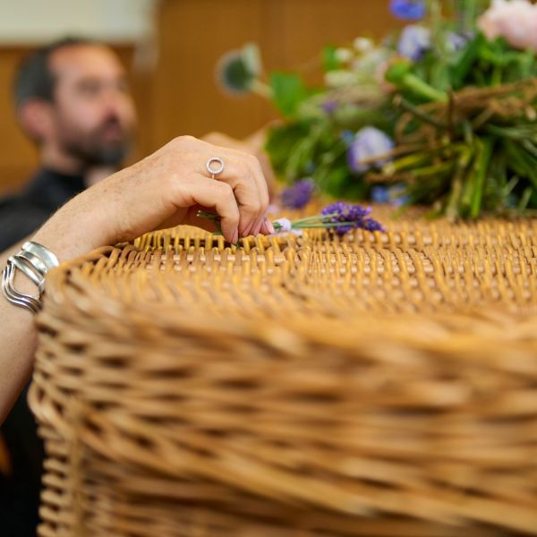 Placing sprigs of lavender on coffin 2