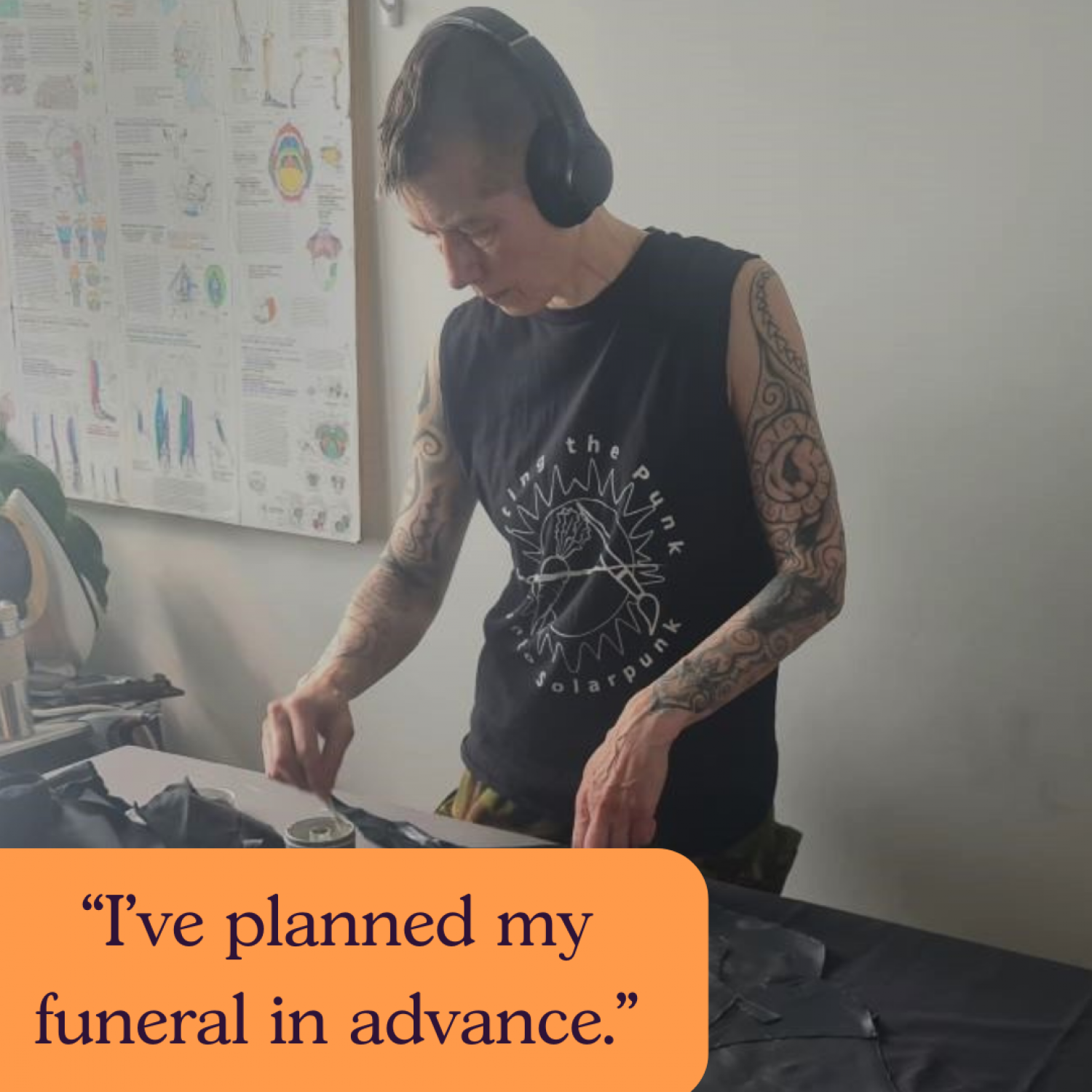 Text: I've already planned my funeral. Image: person with black top and tattoos and headphones sewing