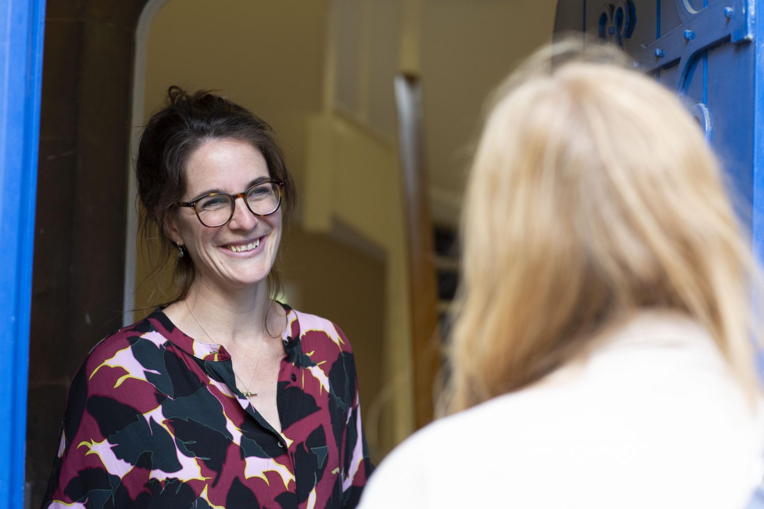 Poppy's staff at open door welcoming clients | Poppy's funerals | London funeral director