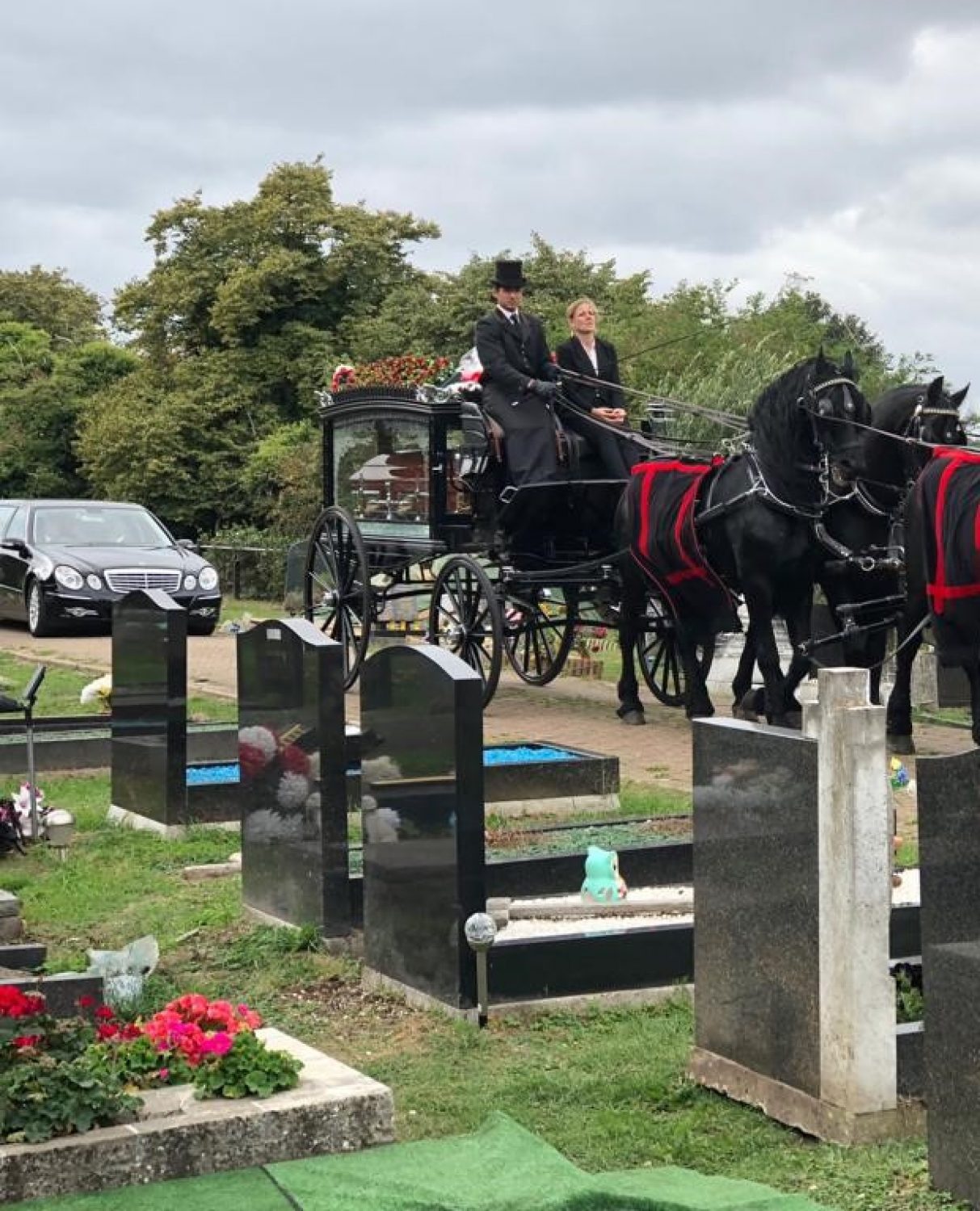 Horse drawn carriage and gravestones