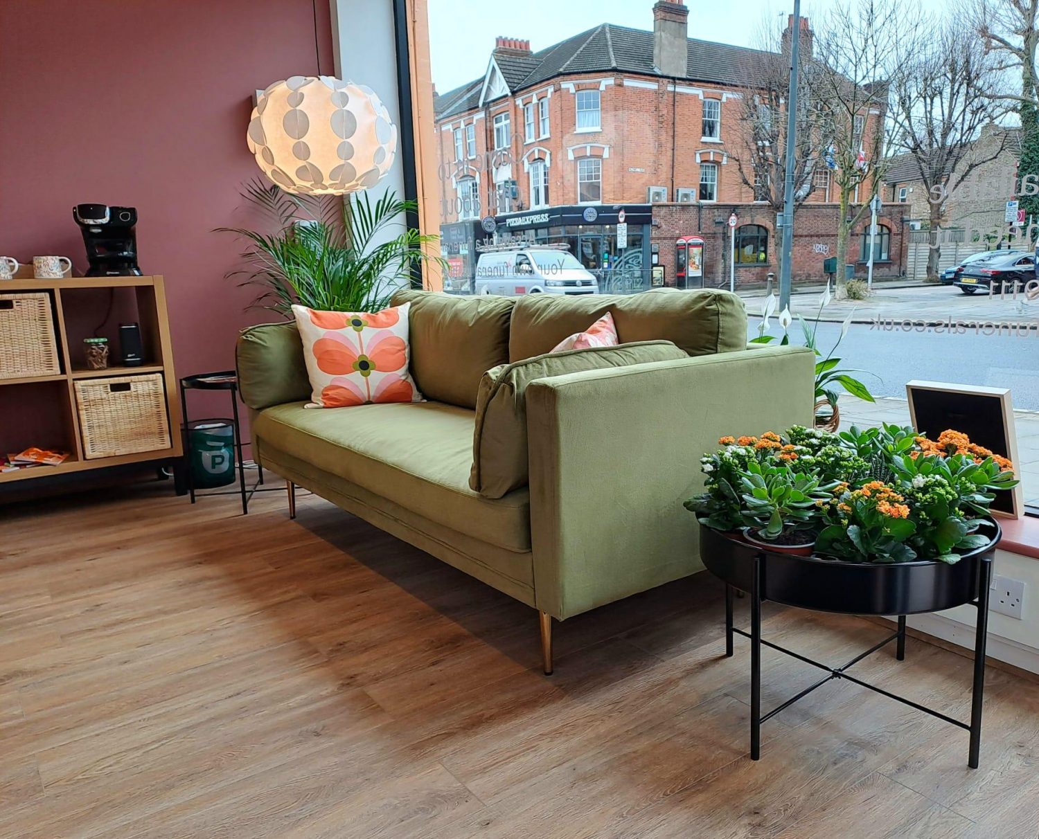 Interior of Poppy's Sheen with sofa and plants