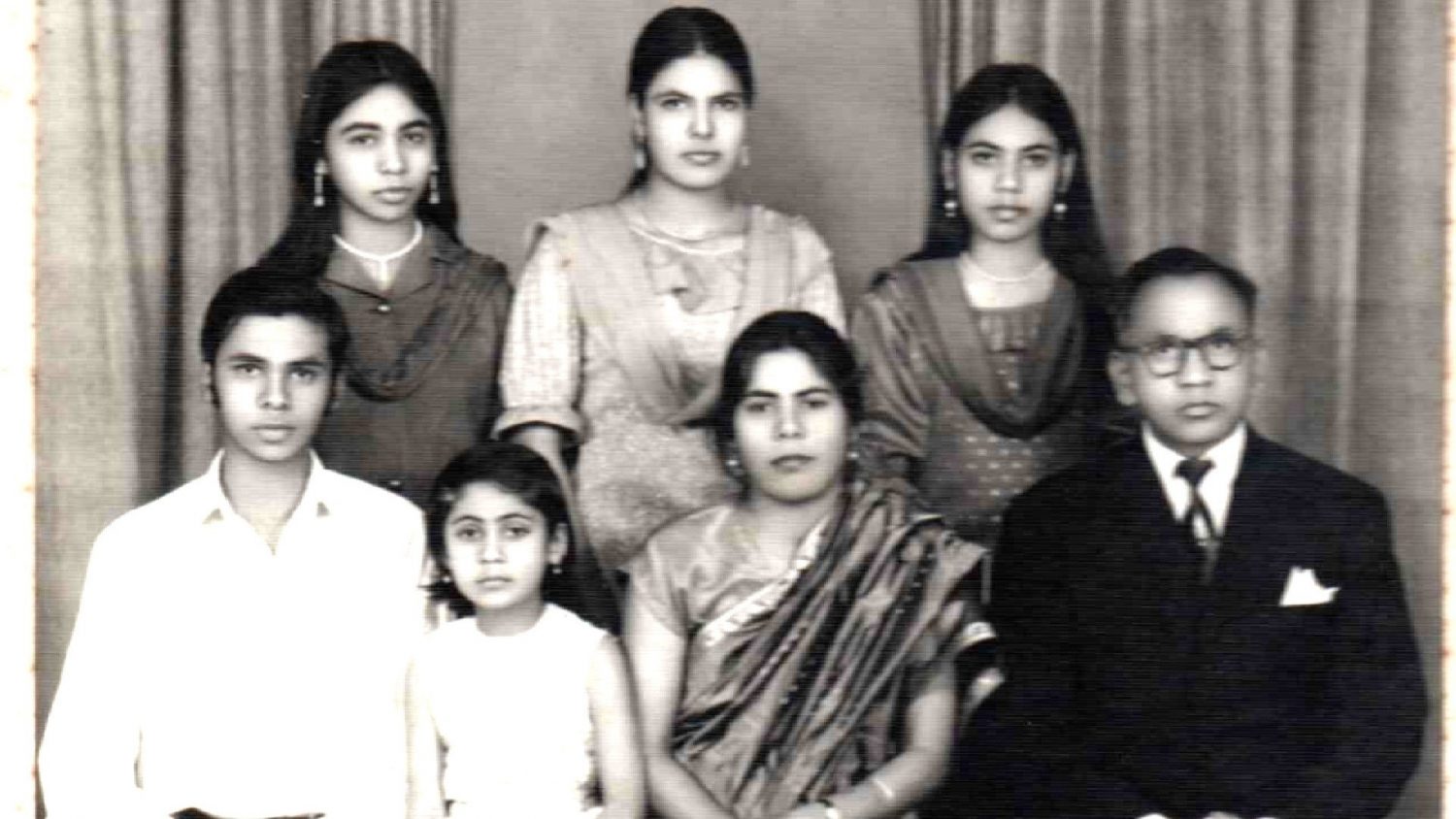 Family group in formal dress, black and white photo