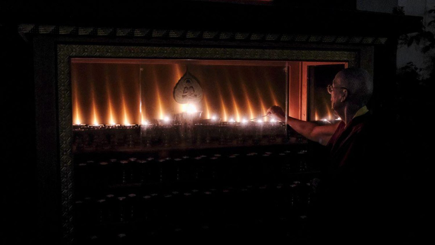 Lama Zangmo, Buddhist practitioner, lighting candles