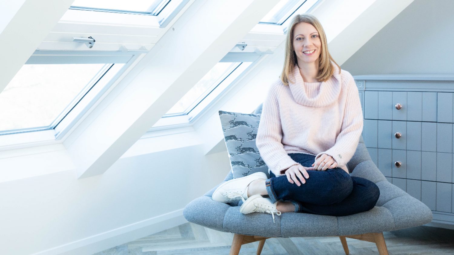 Carla Miller sitting by window with light coming through | Poppy's funerals | London funeral director