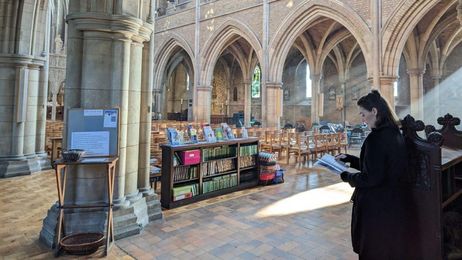 Chloe Miller Smith, Poppy's funeral director on the day, at back of church with light streaming in