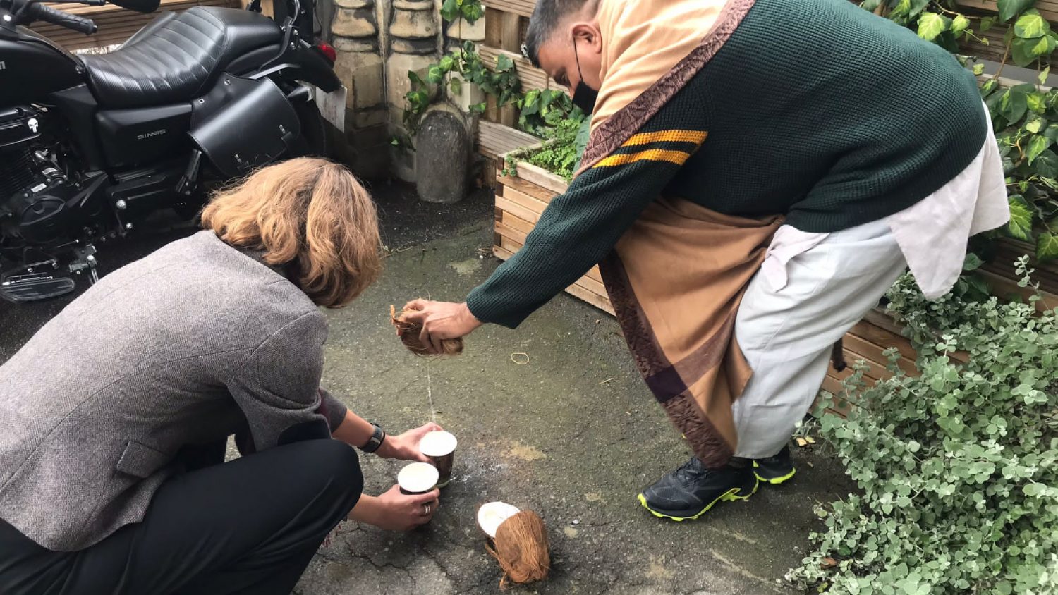 Clare Montagu cracking coconuts, Poppy's, London funeral directors
