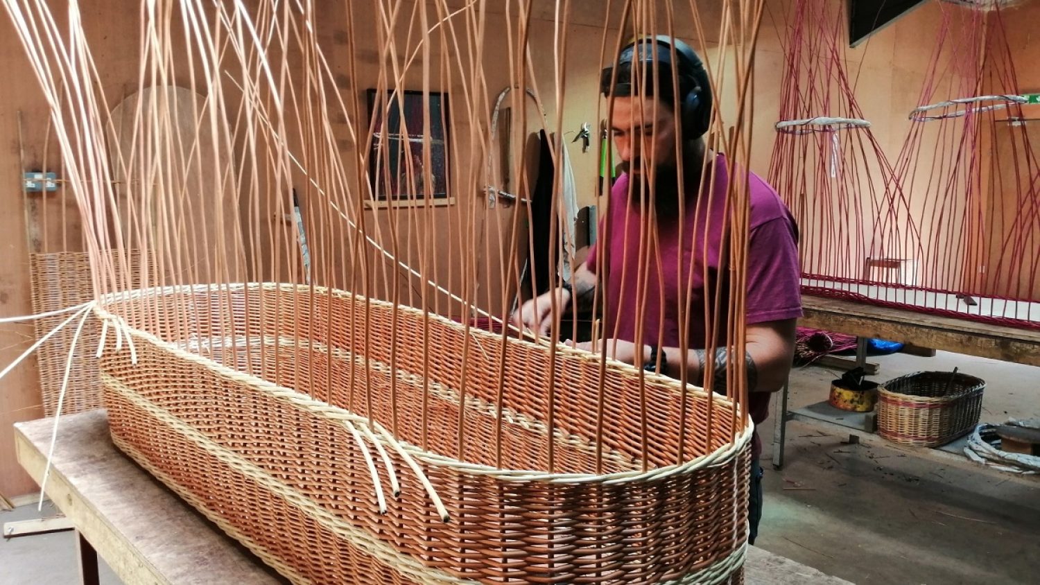 Musgrove Willows team member weaving willow coffin, Poppy's, London funeral directors