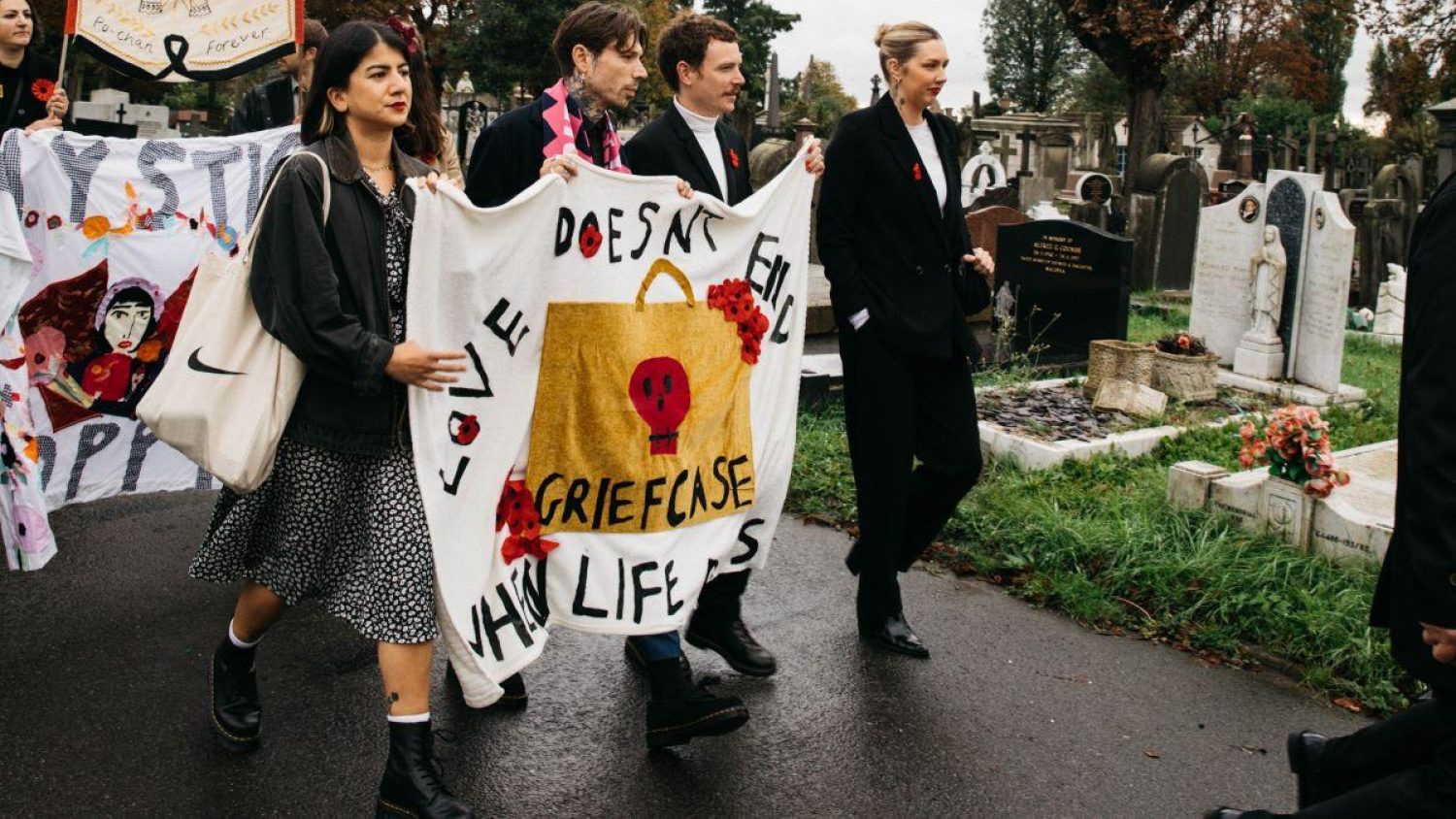 Poppy's friends carrying handmade banners at her funeral