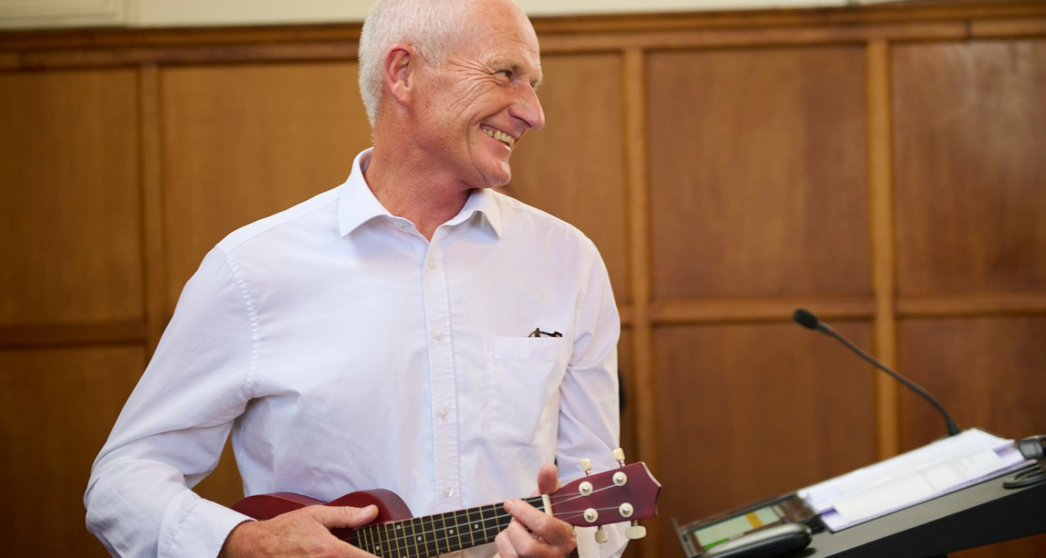 man plays ukelele in funeral service for non religious songs