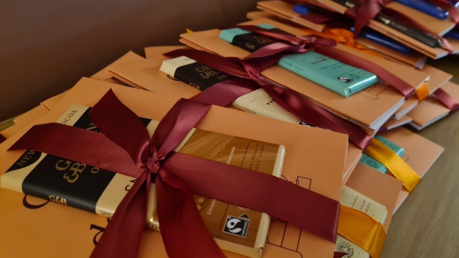 Green and Black's chocolate and Poppy's Guide to Great Death Care booklet tied with red ribbons