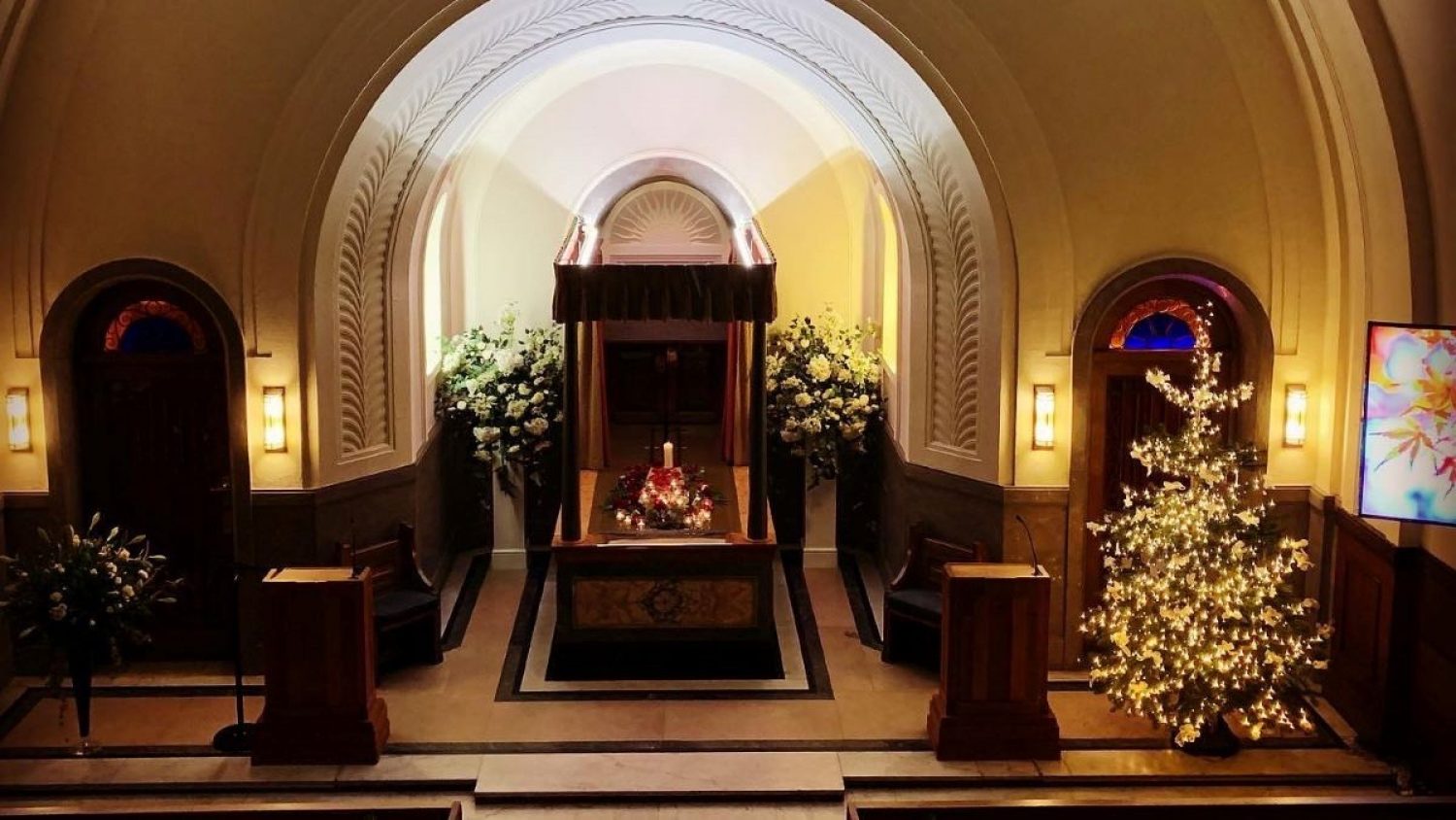 Inside Mortlake Crematorium with Christmas tree lit with white lights