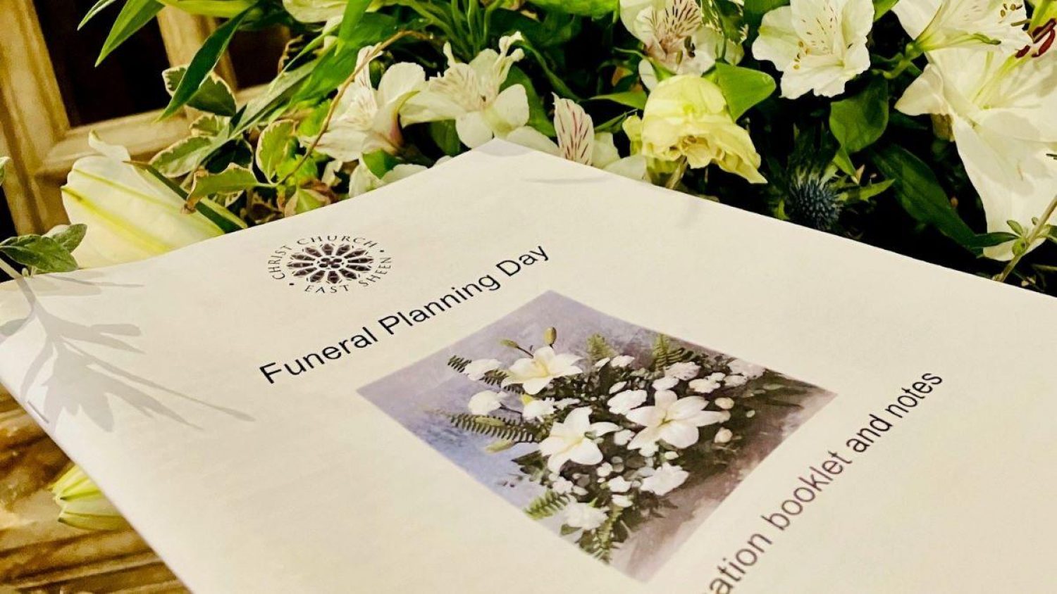 A booklet with 'Funeral Planning Day' and picture of flowers on the cover