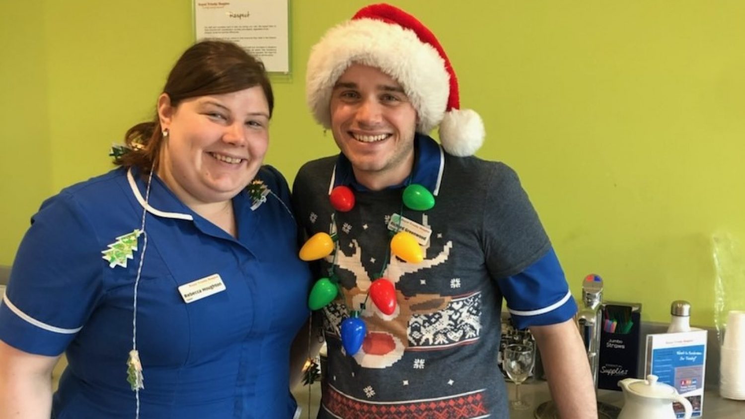 Staff at Royal Trinity Hospice in uniform and Christmas jumper and decorations