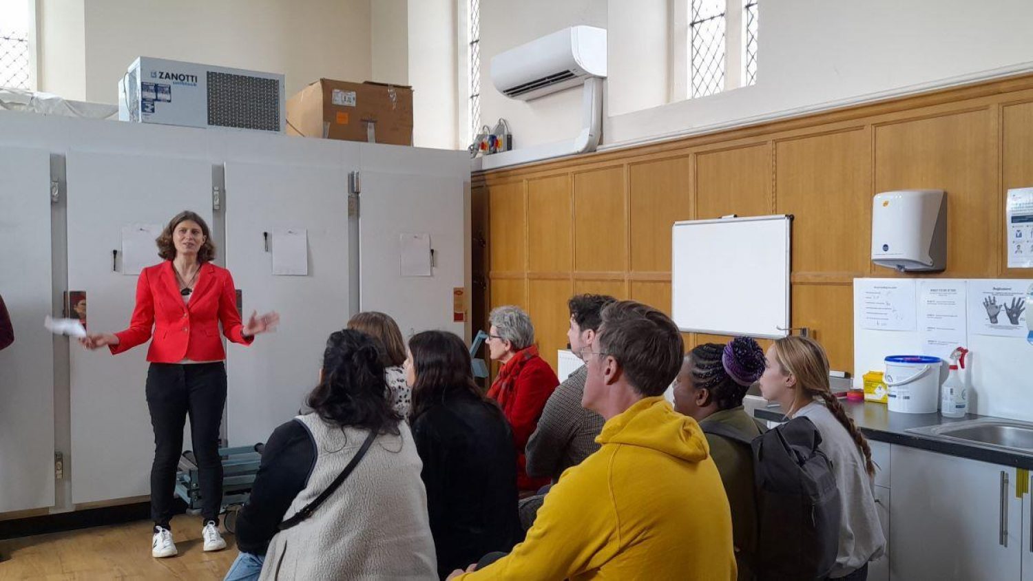 Poppy's CEO Clare Montagu speaking in front of audience at Poppy's mortuary open day