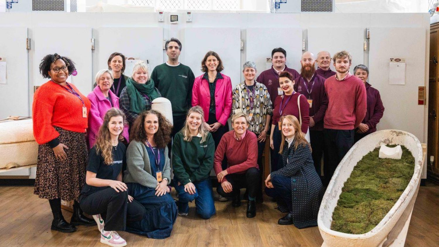 Poppy's team with Loop Biotech team with mortuary fridges behind and mushroom coffin lined with moss in front