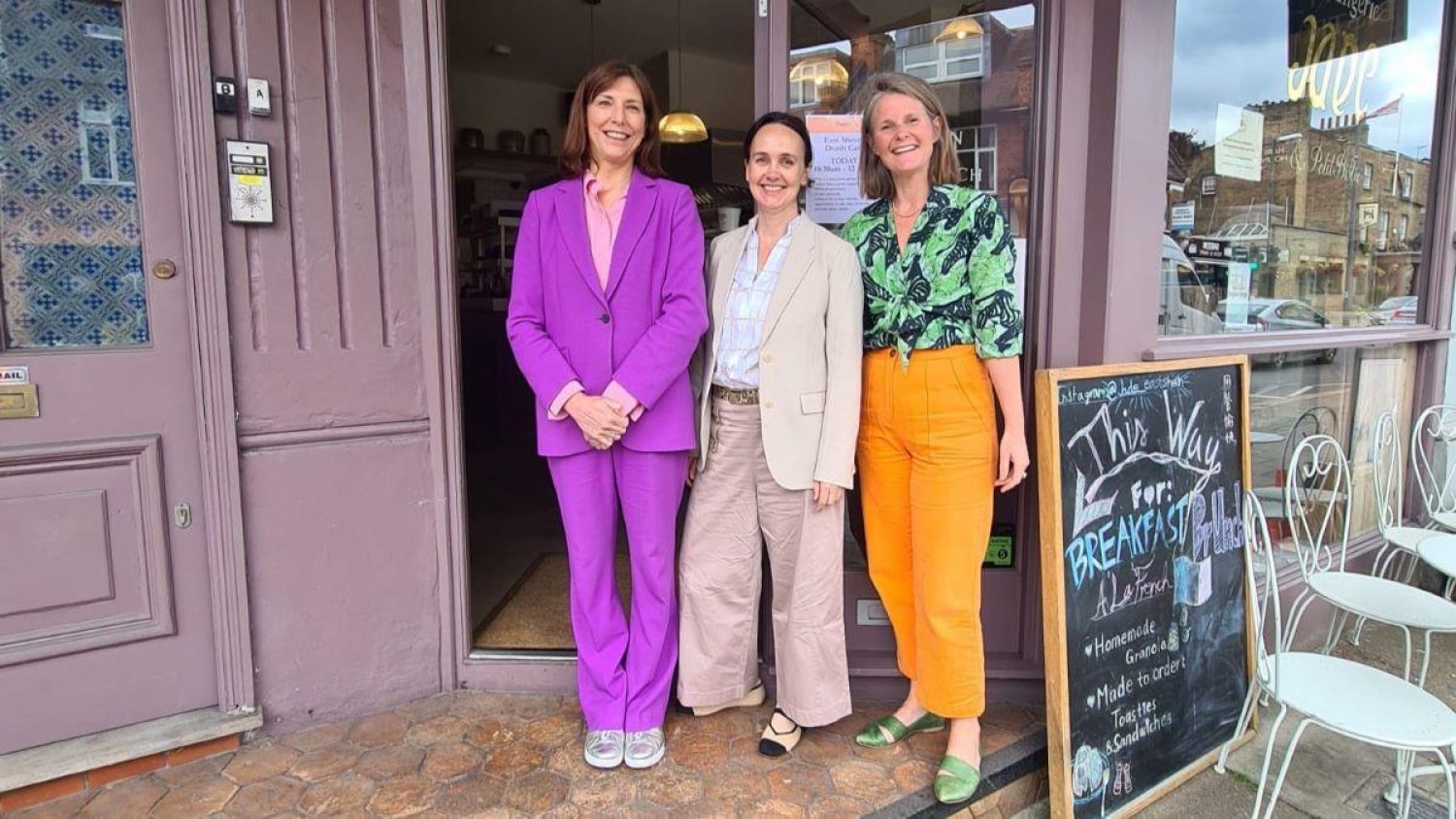 Death cafe facilitators - Natalie in purple, Diane in cream and Poppy in orange outside café in East Sheen