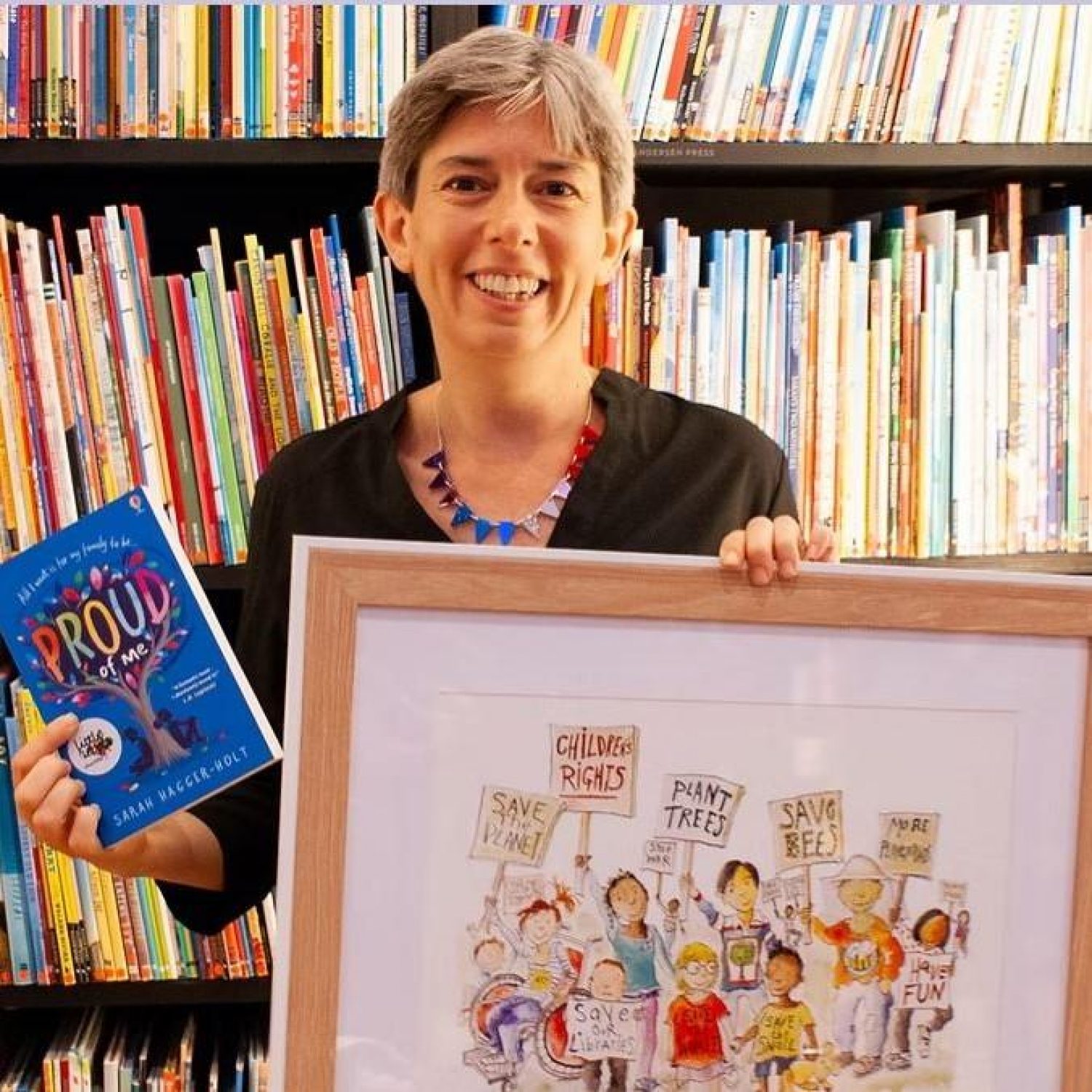 Sarah Hagger-Holt, Poppy's content editor, with book and bookshelves behind