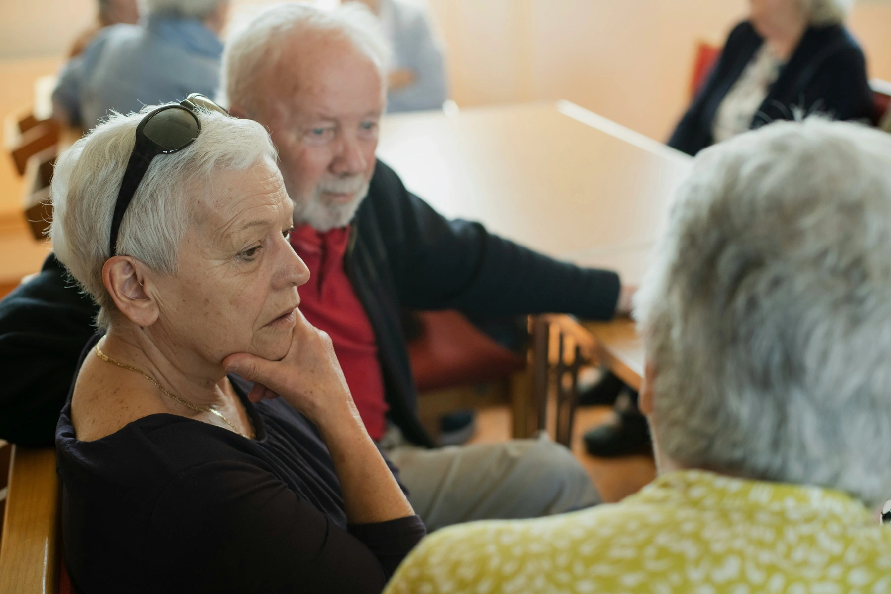 Three middle aged people talk to each other - close of up of their heads and shoulders