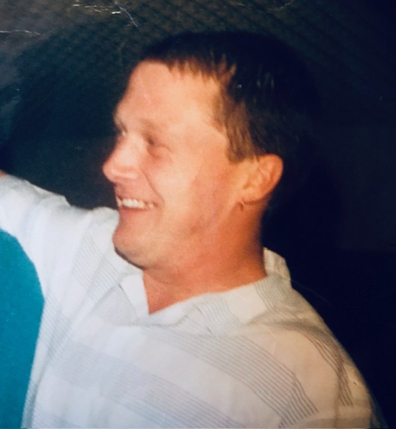 Holly's dad, Lee. Just his head and shoulders, and he is smiling at something out of view