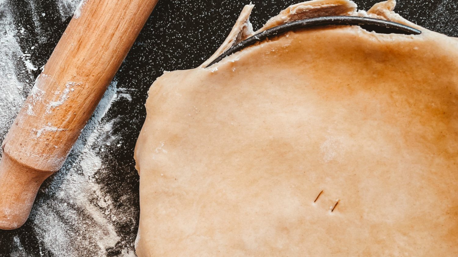 Pie ready for baking with rolling pin