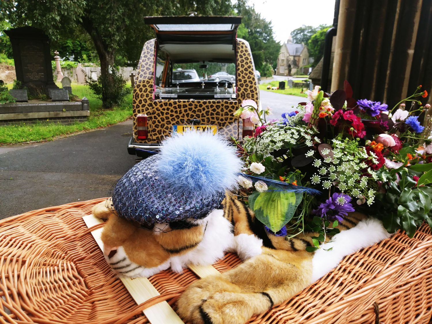 Coffin with soft toy leopard and leopard print hearse | Poppy's funerals | London funeral director